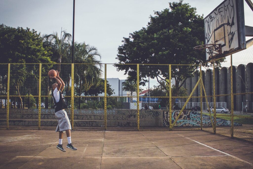 man playing basketball outdoors